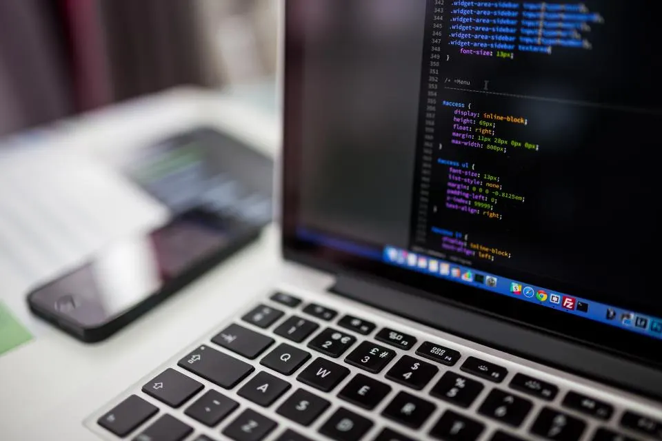Code displayed on a laptop during website maintenance